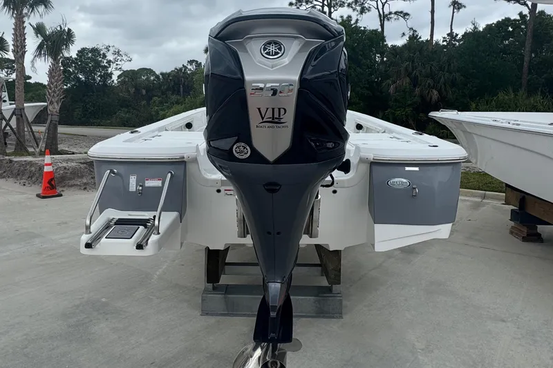 Slide: The Image of 2024 NauticStar 224 Bay boat with Yamaha outboard motor, docked outdoors. - 9