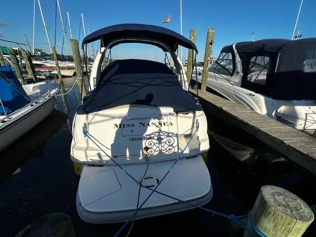 Slide: The Image of 2008 Sea Ray 280 Sundancer docked at marina, covered and secured with ropes. - 1