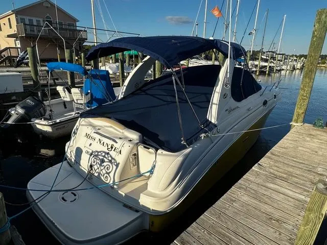 Slide: The Image of 2008 Sea Ray 280 Sundancer docked at marina with blue canopy. - 2