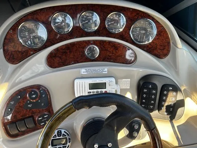 Slide: The Image of Dashboard of a 2008 Sea Ray 280 Sundancer boat with gauges and controls. - 6