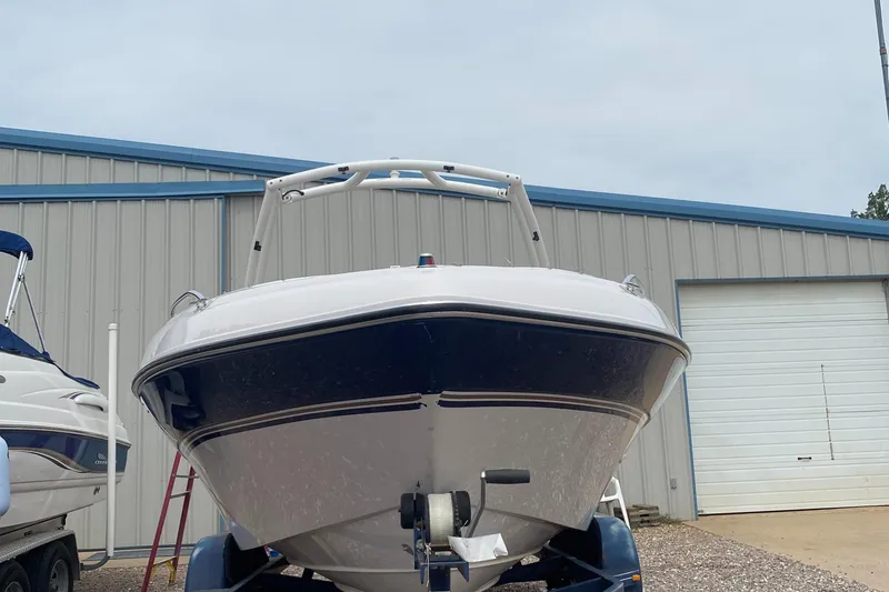 Slide: The Image of 1997 Four Winns 200 Horizon boat on trailer in front of storage building. - 2