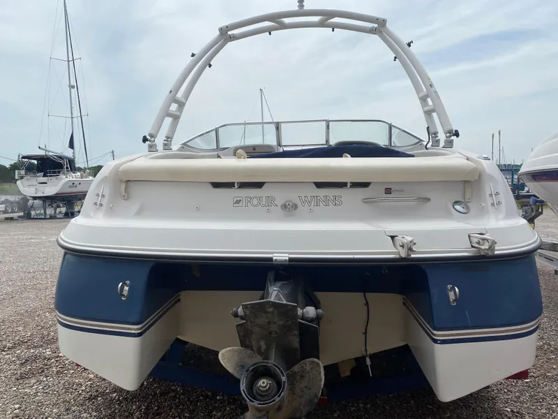 Slide: The Image of 1997 Four Winns 200 Horizon boat, rear view, in a marina. - 3