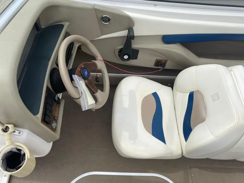 Slide: The Image of 1997 Four Winns 200 Horizon boat interior with steering wheel and white seats. - 8