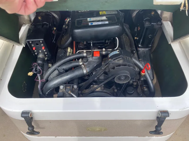 Slide: The Image of 1997 Four Winns 200 Horizon boat engine compartment with visible components. - 9