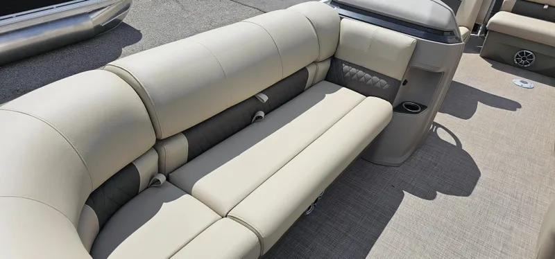 Slide: The Image of 2024 Sun Tracker Party Barge 20 DLX interior seating with beige upholstery. - 5