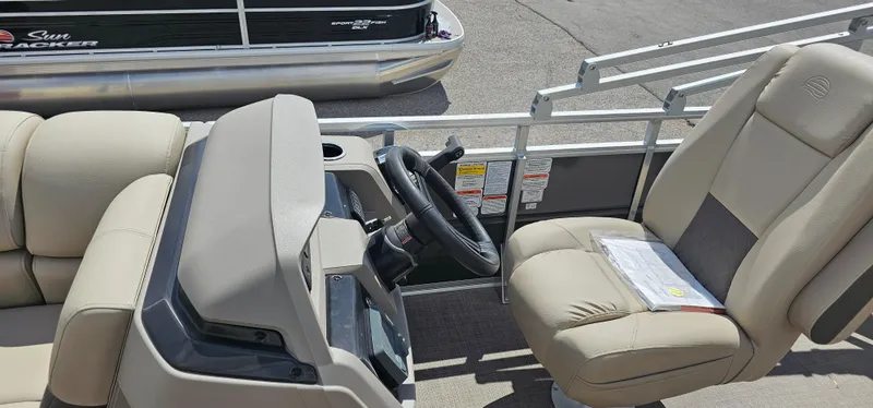 Slide: The Image of 2024 Sun Tracker Party Barge 20 DLX interior with steering console and seating. - 7