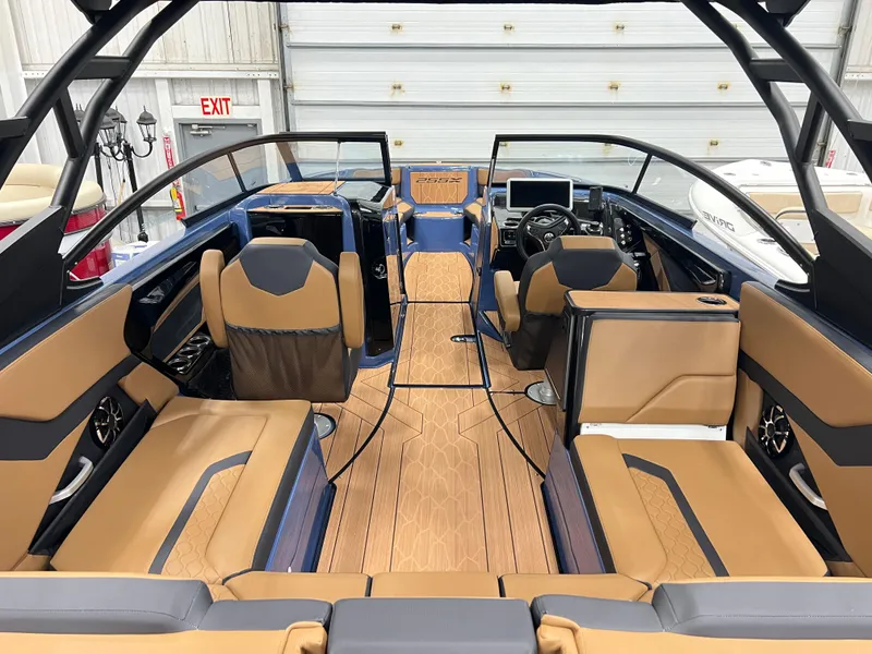 Slide: The Image of 2024 Yamaha Boats 255XD interior with tan and black seating, modern dashboard, and spacious layout. - 6