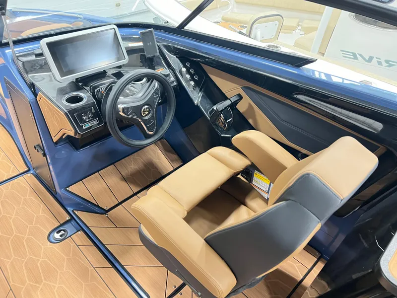 Slide: The Image of 2024 Yamaha Boats 255XD cockpit with modern steering wheel and touchscreen display. - 7