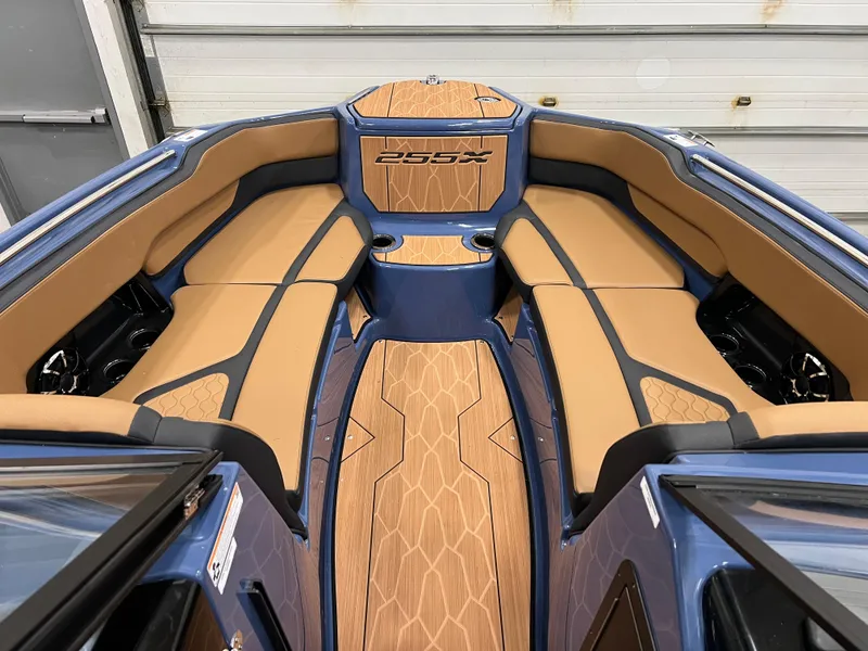 Slide: The Image of 2024 Yamaha Boats 255XD interior with tan and black seating. - 9