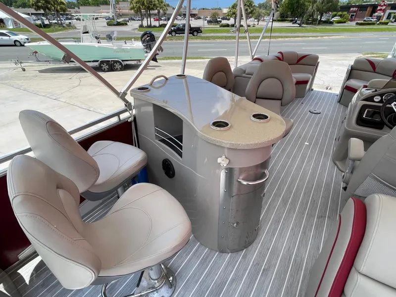 Slide: The Image of 2018 Berkshire 250E STS pontoon boat interior with seating and helm station. - 10