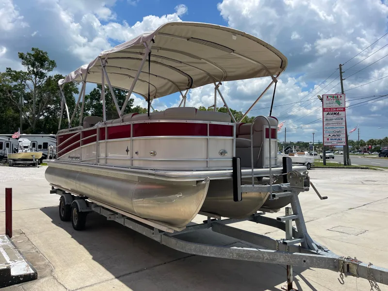Slide: The Image of 2018 Berkshire 250E STS pontoon boat on trailer with canopy in parking lot. - 4