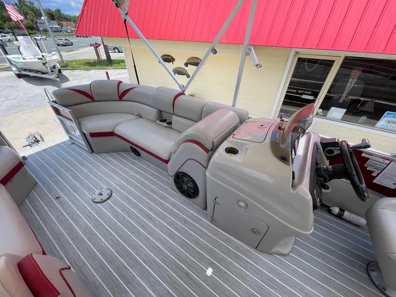 Slide: The Image of 2018 Berkshire 250E STS pontoon boat interior with gray and red seating. - 7