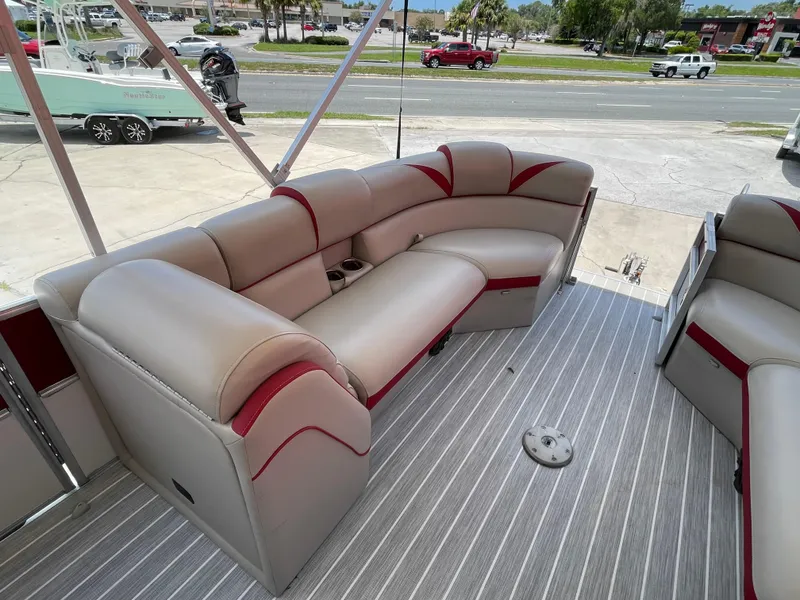 Slide: The Image of 2018 Berkshire 250E STS pontoon boat interior with beige and red seating. - 8