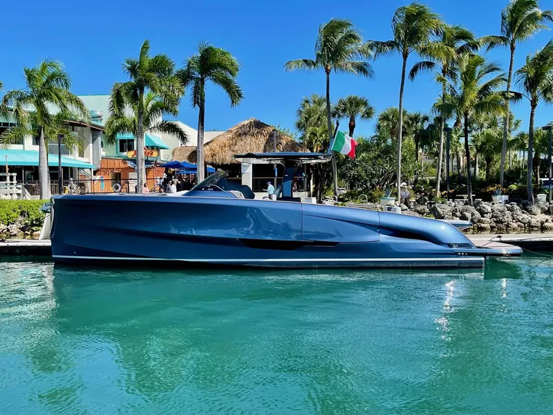 Slide: The Image of 2023 Solaris Power SP 44 yacht docked in tropical marina with palm trees. - 0