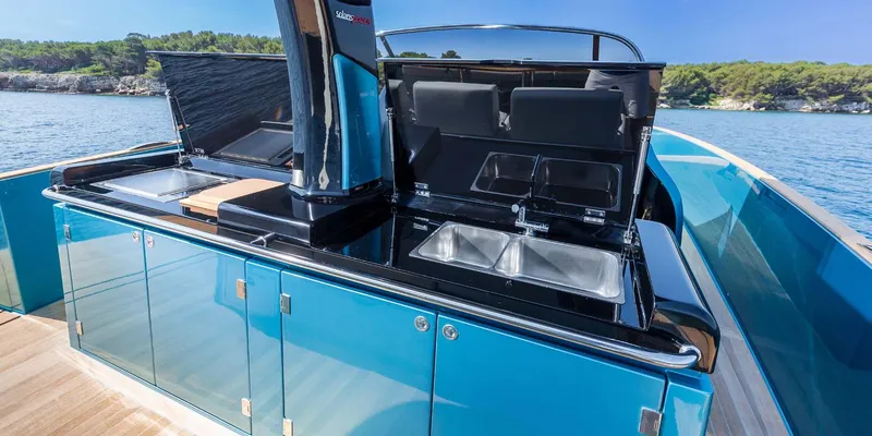 Slide: The Image of 2023 Solaris Power SP 44 yacht with sleek outdoor kitchen and ocean backdrop. - 11