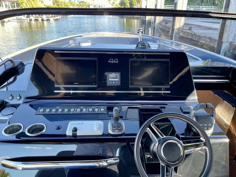 Slide: The Image of 2023 Solaris Power SP 44 yacht dashboard with dual screens and steering wheel. - 9