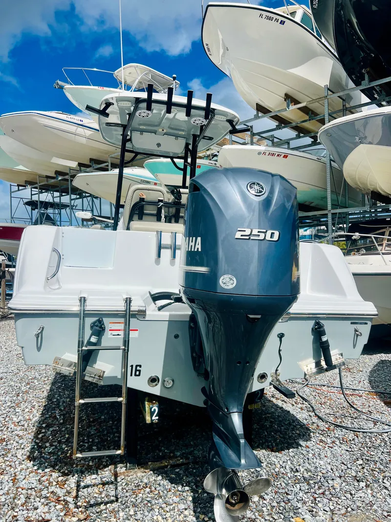 Slide: The Image of 2021 Sportsman Open 232 Center Console boat with Yamaha 250 engine, docked outdoors. - 11