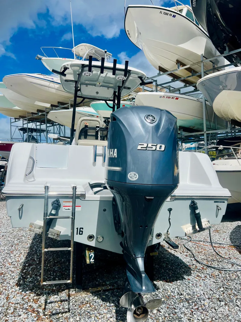 Slide: The Image of 2021 Sportsman Open 232 Center Console boat with Yamaha 250 engine, docked outdoors. - 12