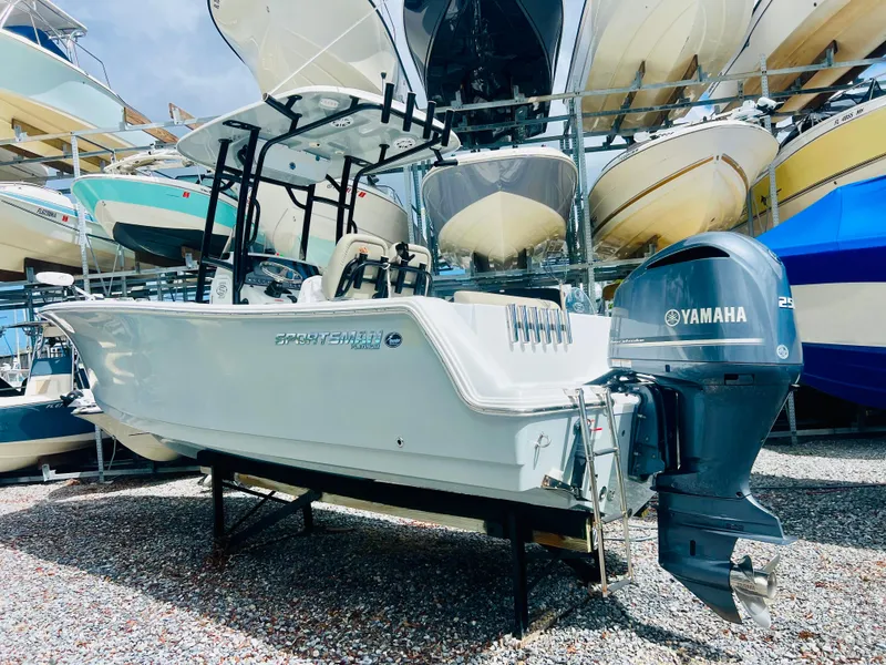 Slide: The Image of 2021 Sportsman Open 232 Center Console boat with Yamaha engine, displayed in a boatyard. - 13