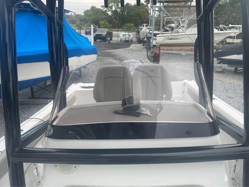 Slide: The Image of 2021 Sportsman Open 232 Center Console boat, featuring dual seats and a clear windshield. - 4