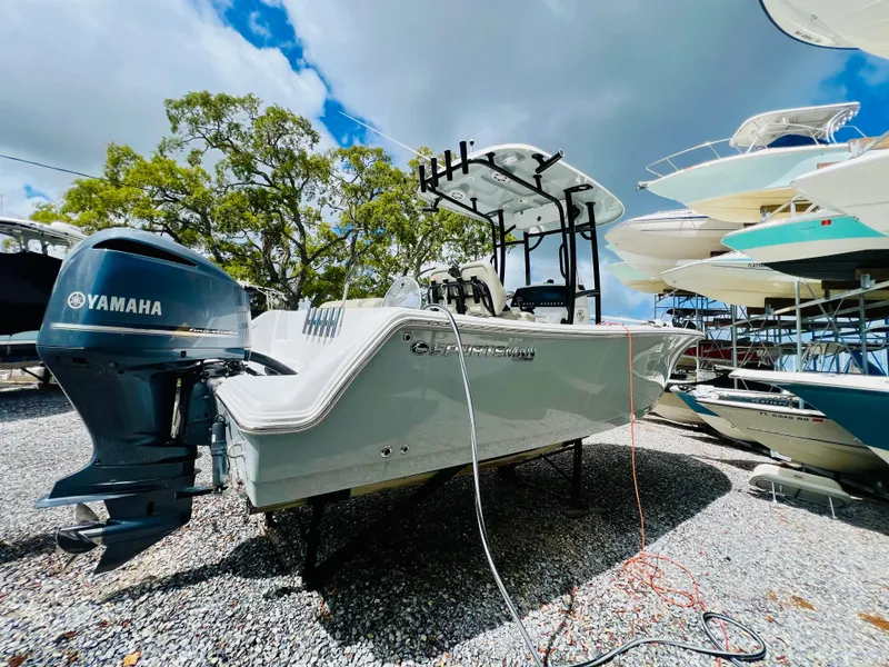 Slide: The Image of 2021 Sportsman Open 232 Center Console boat with Yamaha engine, parked outdoors on gravel. - 9