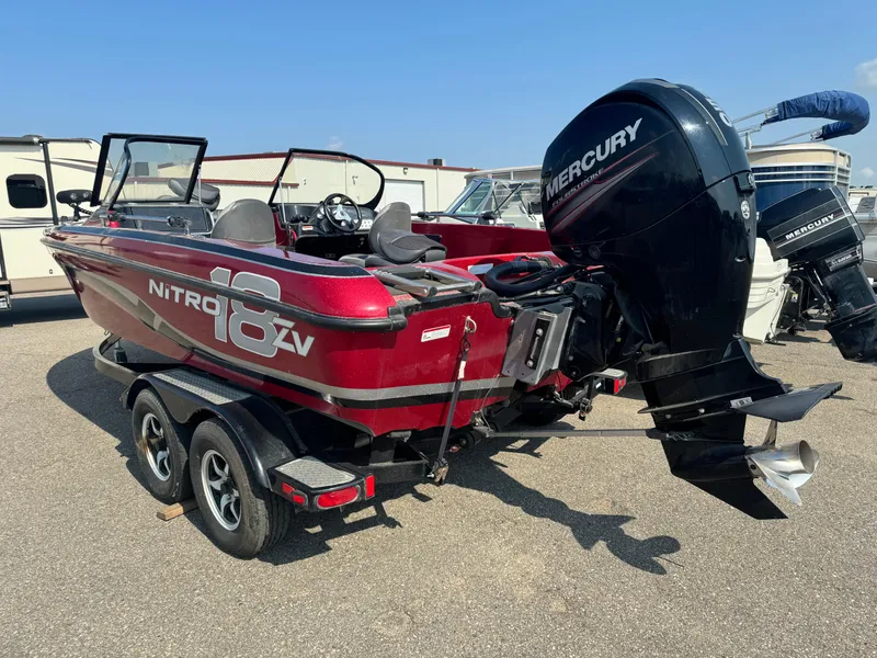 Slide: The Image of 2015 Nitro ZV 18 boat with Mercury outboard motor on a trailer. - 4