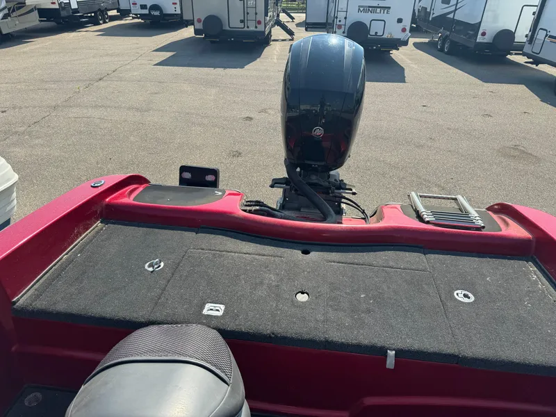 Slide: The Image of 2015 Nitro ZV 18 boat with outboard motor in a parking lot. - 7