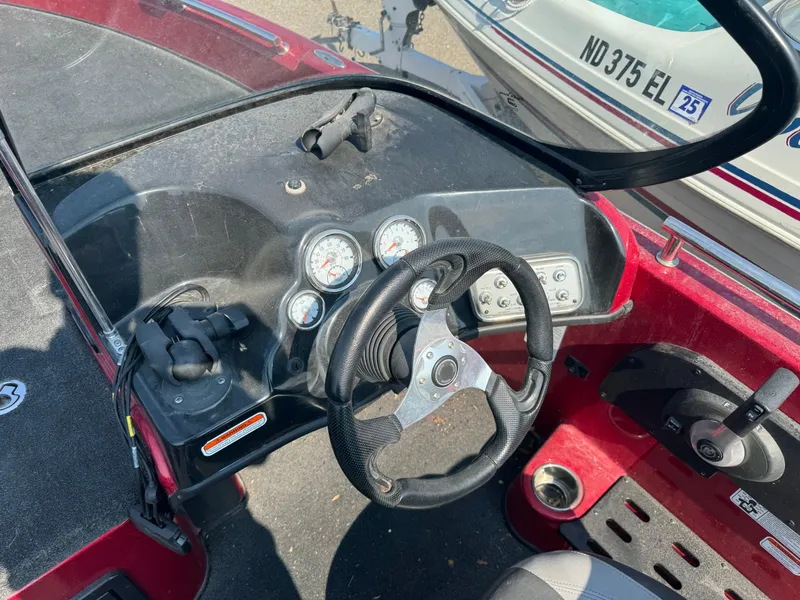 Slide: The Image of 2015 Nitro ZV 18 boat dashboard with steering wheel and gauges. - 9