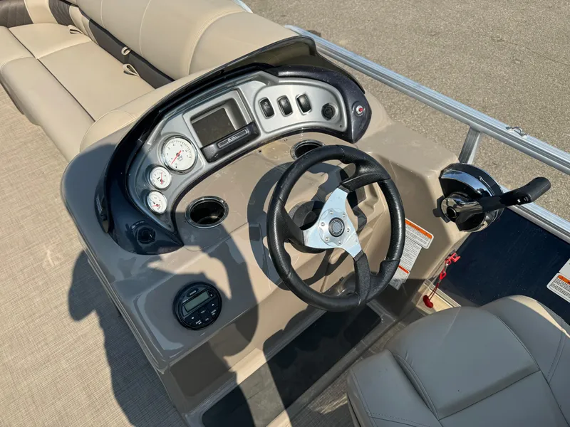 Slide: The Image of 2021 Sun Tracker Party Barge 20 DLX helm with steering wheel and control panel. - 16