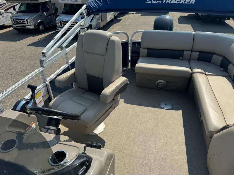 Slide: The Image of 2021 Sun Tracker Party Barge 20 DLX interior with captain's chair and seating. - 6