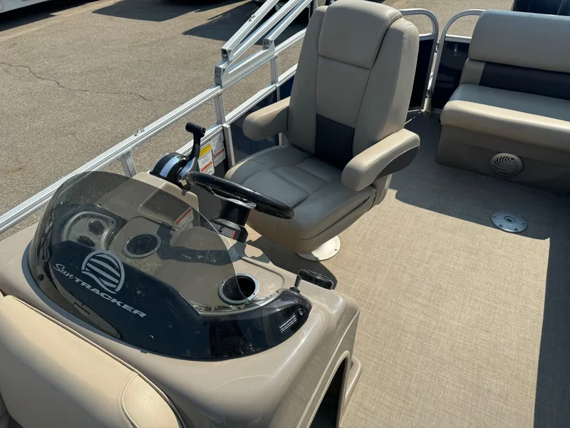 Slide: The Image of 2021 Sun Tracker Party Barge 20 DLX interior with captain's chair and steering console. - 7