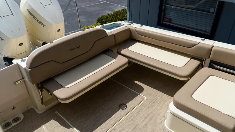 Slide: The Image of 2025 Chris-Craft 32 Calypso boat interior with beige seating and Mercury engines. - 11