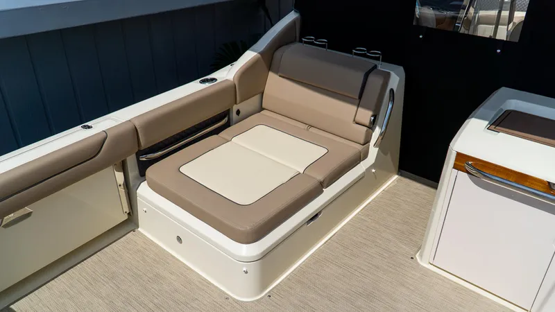 Slide: The Image of 2025 Chris-Craft 32 Calypso boat interior with beige seating and modern design. - 15