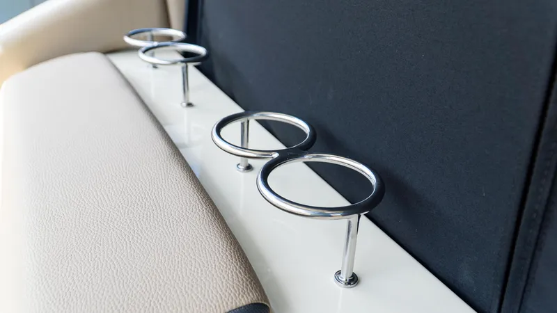 Slide: The Image of Cup holders on a 2025 Chris-Craft 32 Calypso boat, featuring sleek metal design. - 18