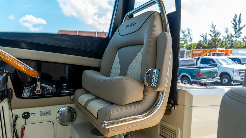 Slide: The Image of 2025 Chris-Craft 32 Calypso helm seat with luxurious beige upholstery and chrome accents. - 31