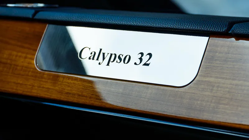 Slide: The Image of 2025 Chris-Craft 32 Calypso nameplate on wooden panel. - 34