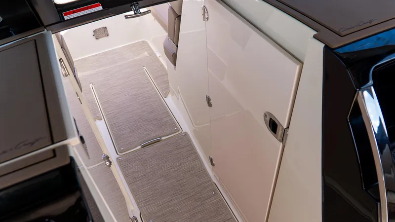 Slide: The Image of Interior view of 2025 Chris-Craft 32 Calypso boat, featuring sleek design and carpeted flooring. - 40