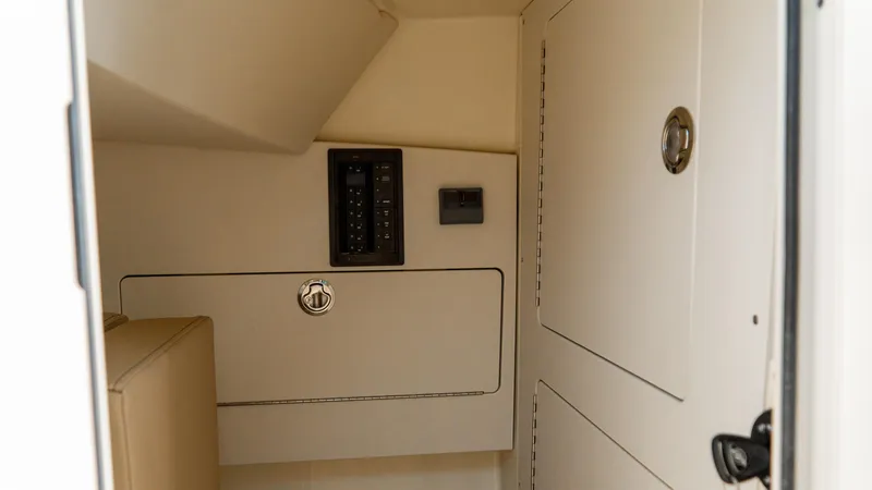 Slide: The Image of Interior cabin of 2025 Chris-Craft 32 Calypso boat, featuring control panel and storage. - 43