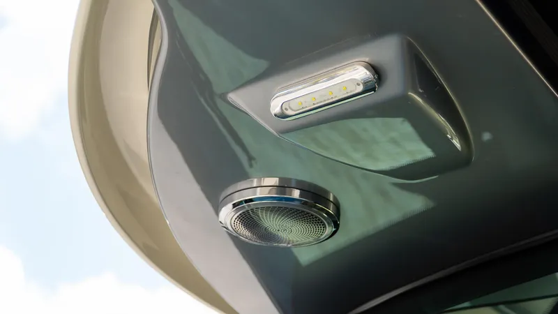 Slide: The Image of 2025 Chris-Craft 32 Calypso boat detail showing LED light and speaker on deck. - 46