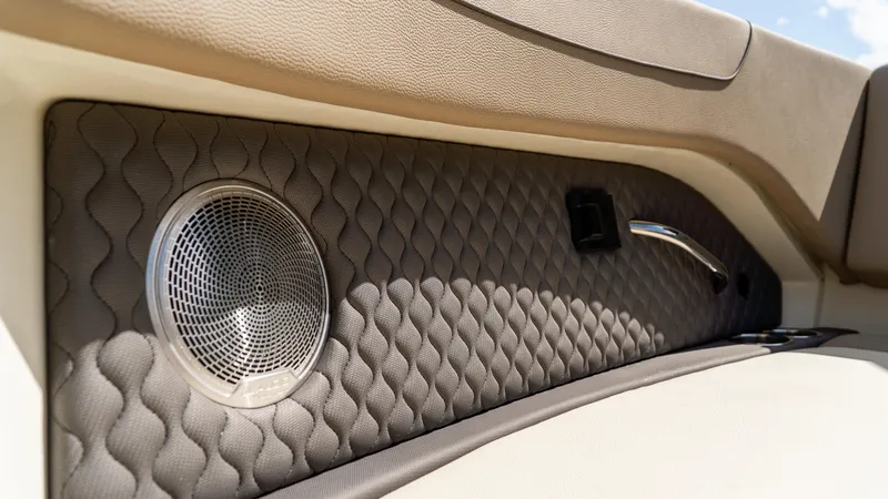 Slide: The Image of Luxurious interior detail of 2025 Chris-Craft 32 Calypso boat with quilted panel and speaker. - 49
