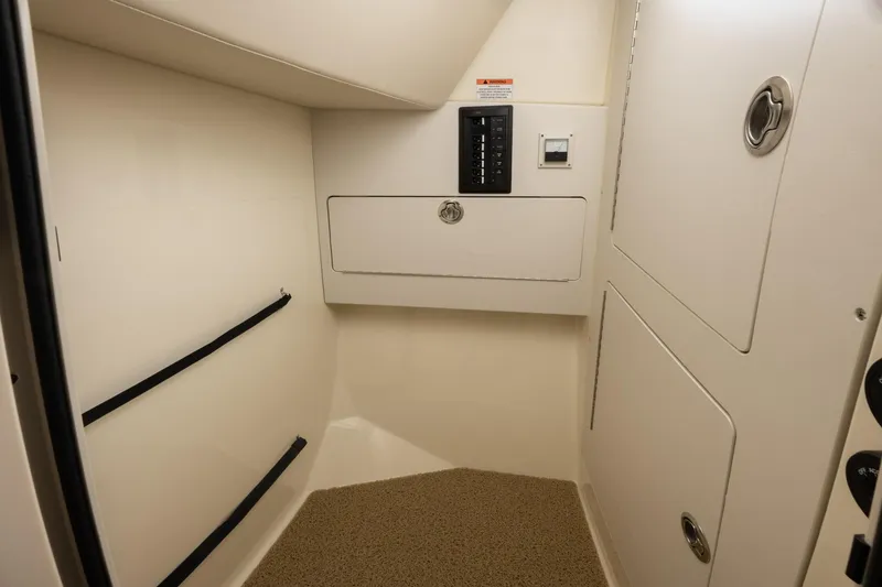 Slide: The Image of Interior cabin of 2025 Chris-Craft 32 Calypso boat with storage compartments and control panel. - 62