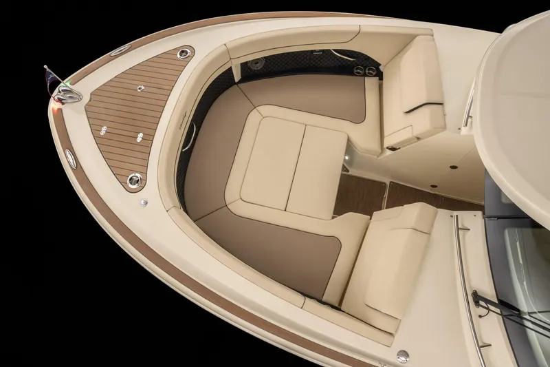 Slide: The Image of 2025 Chris-Craft 32 Calypso boat interior with beige seating and wooden deck. - 63