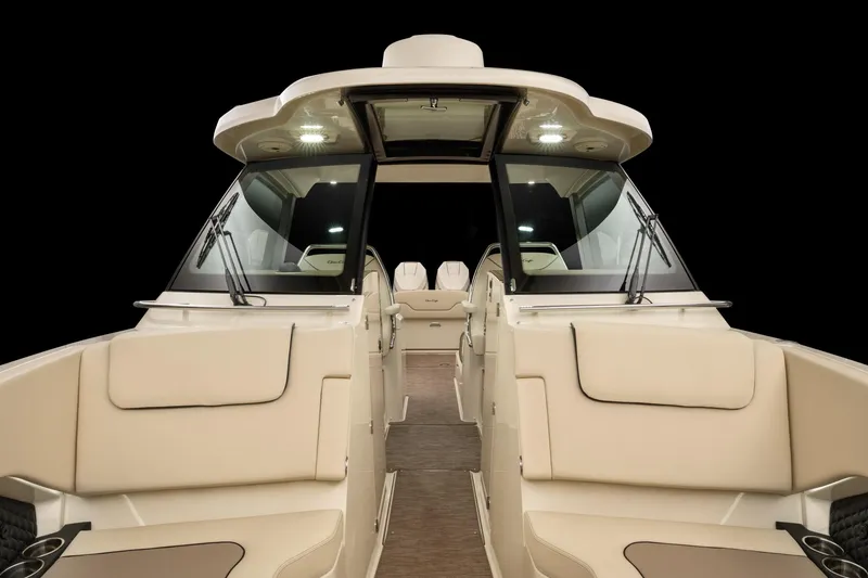 Slide: The Image of 2025 Chris-Craft 32 Calypso boat interior with beige seating and modern design. - 64