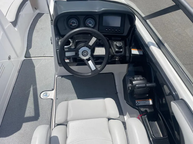 Slide: The Image of 2018 Yamaha Boats AR240 cockpit with steering wheel and control panel. - 2