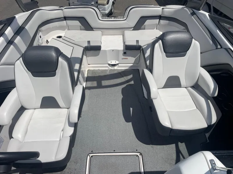 Slide: The Image of 2018 Yamaha Boats AR240 interior with dual captain's chairs and spacious seating area. - 5