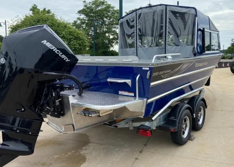 Slide: The Image of 2024 Spartan 200 Astoria boat with Mercury outboard motor on trailer. - 3