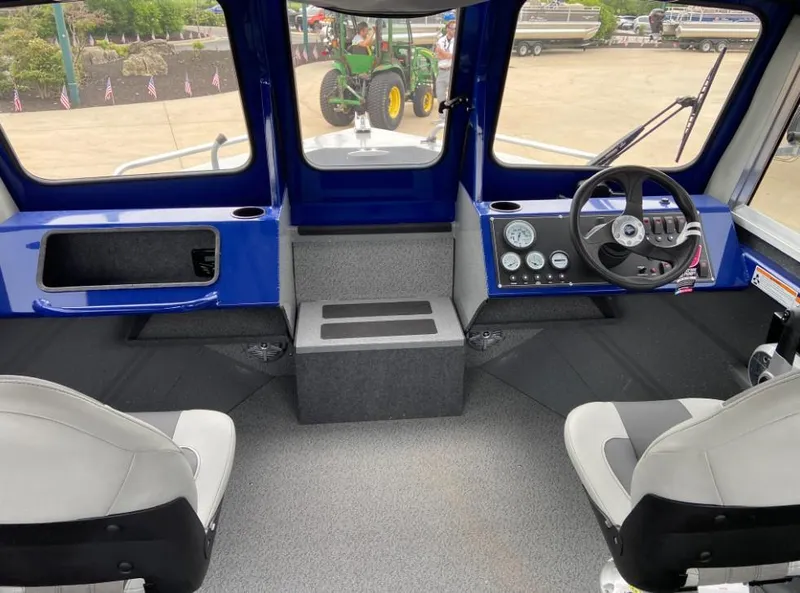 Slide: The Image of 2024 Spartan 200 Astoria boat interior with steering wheel and dashboard. - 4