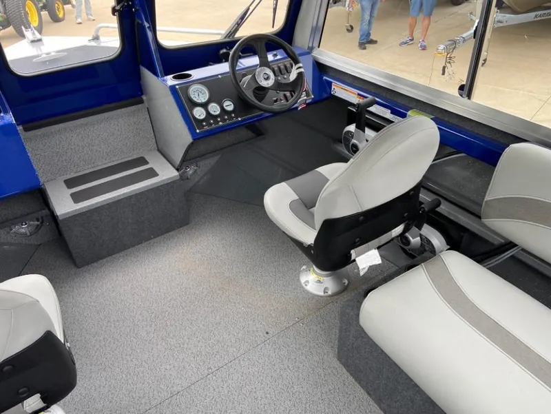 Slide: The Image of Interior of 2024 Spartan 200 Astoria boat with gray seating and control panel. - 5