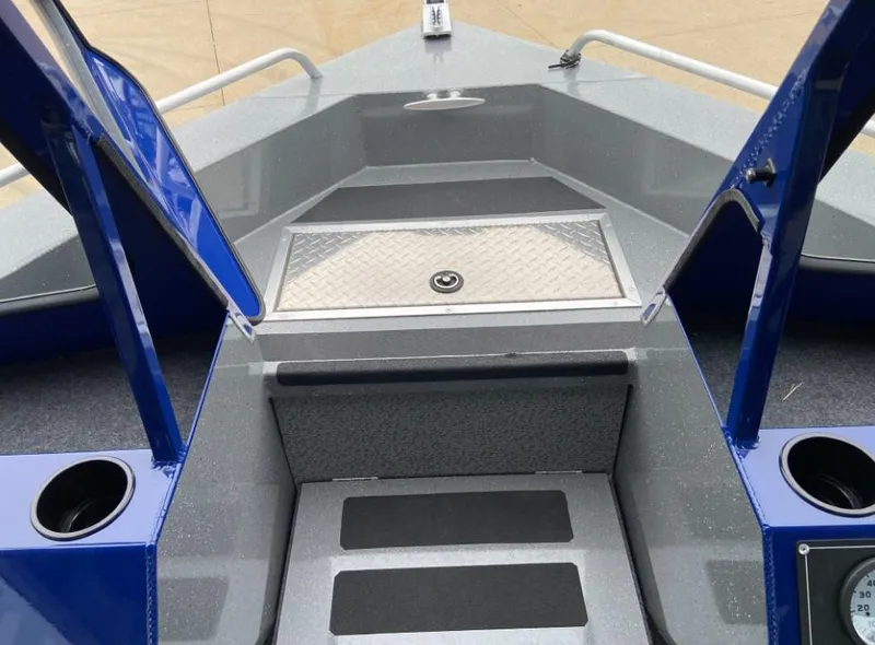 Slide: The Image of 2024 Spartan 200 Astoria boat interior with storage compartment and cup holders. - 7
