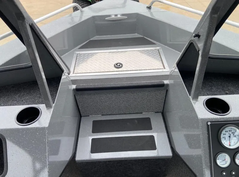 Slide: The Image of 2024 Spartan 200 Astoria boat interior with storage compartment and control panel. - 10